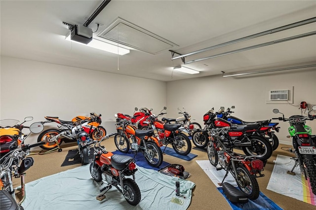 garage featuring a garage door opener and a wall mounted AC