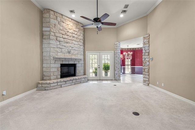 unfurnished living room with french doors, ceiling fan with notable chandelier, light colored carpet, and crown molding