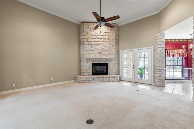 unfurnished living room with ceiling fan, french doors, light colored carpet, and ornamental molding