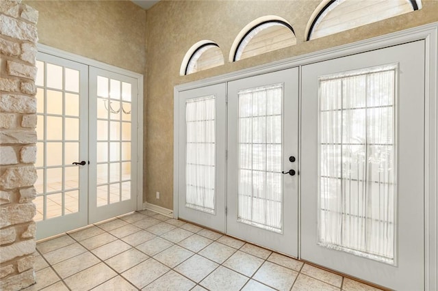 doorway with french doors and light tile patterned floors