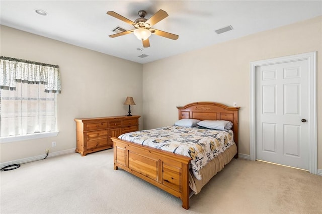 bedroom with ceiling fan and light carpet