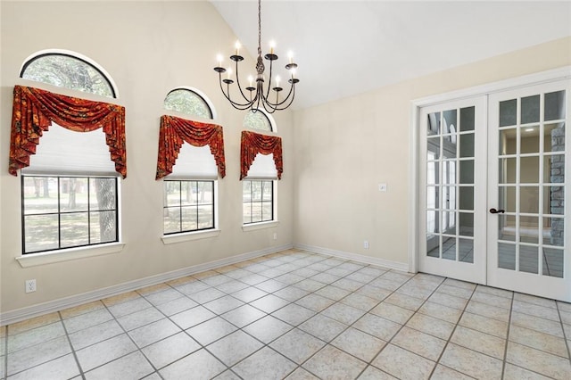 unfurnished dining area featuring a chandelier, light tile patterned floors, vaulted ceiling, and french doors