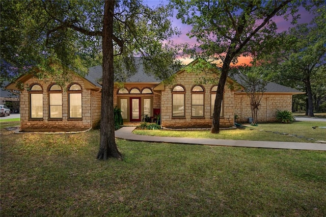 view of front of home with a yard and french doors