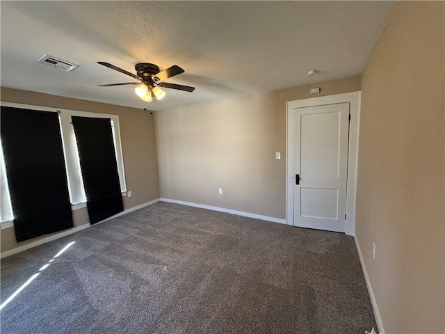 unfurnished bedroom featuring ceiling fan, carpet floors, and a textured ceiling