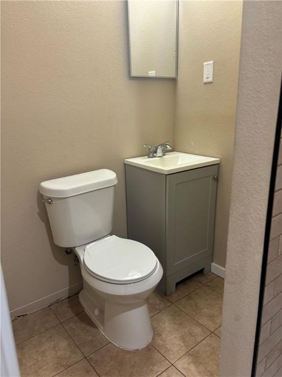 bathroom with tile patterned floors, toilet, and vanity