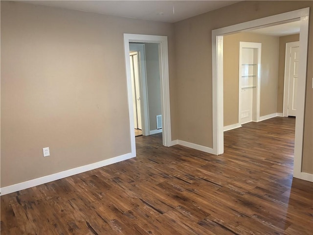 unfurnished room featuring dark hardwood / wood-style floors