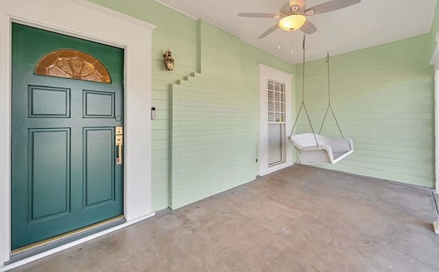 entrance to property featuring ceiling fan and a porch