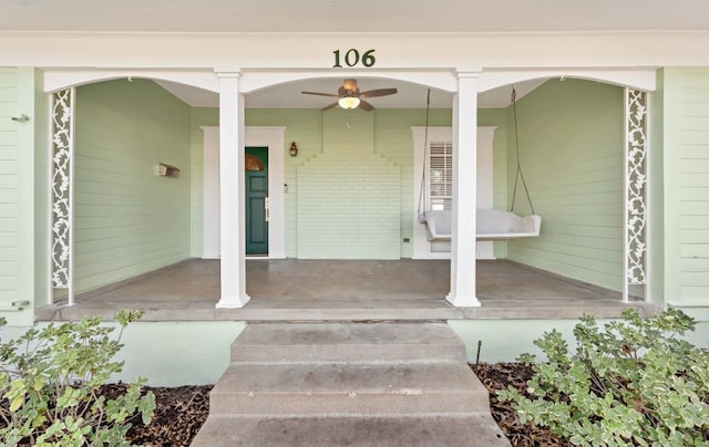 doorway to property featuring ceiling fan and a porch