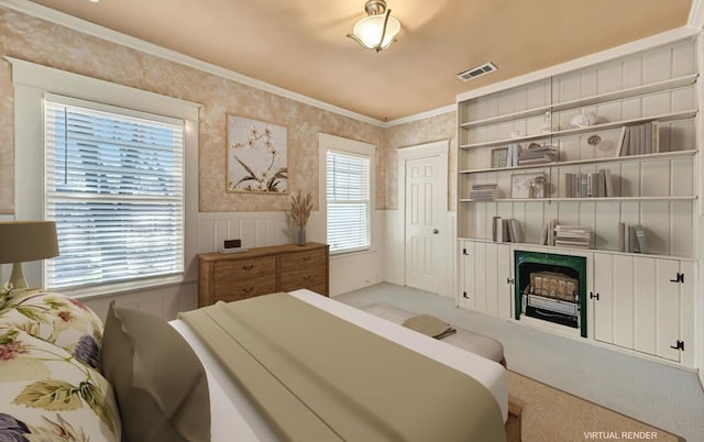 carpeted bedroom featuring crown molding, a fireplace, and multiple windows