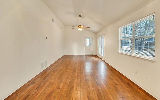 spare room featuring crown molding, ceiling fan, vaulted ceiling, and hardwood / wood-style floors