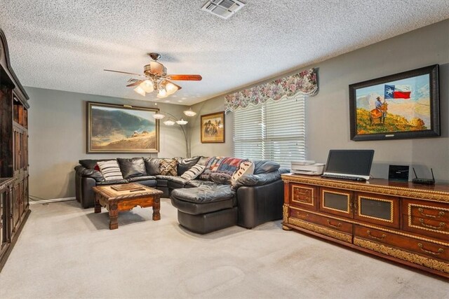 carpeted living room with ceiling fan and a textured ceiling