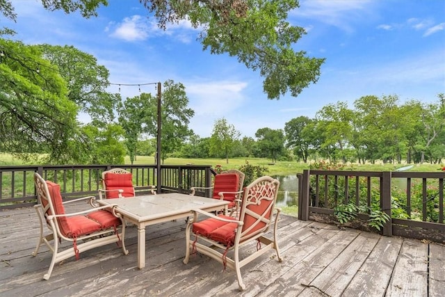 wooden deck featuring a water view