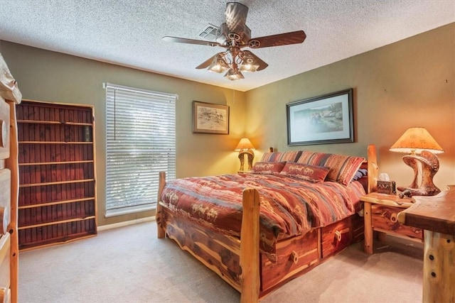 bedroom with a textured ceiling, light colored carpet, multiple windows, and ceiling fan