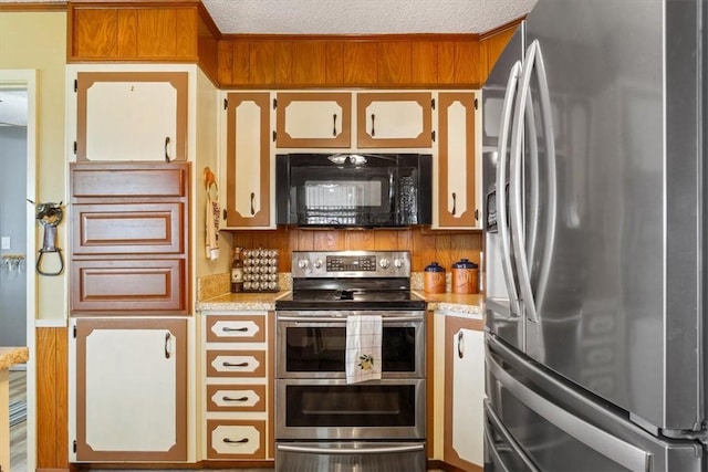 kitchen featuring a textured ceiling and stainless steel appliances