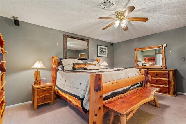 bedroom featuring carpet flooring, ceiling fan, and a textured ceiling