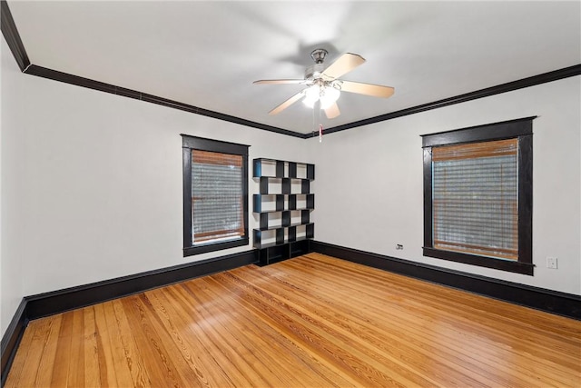 spare room featuring wood-type flooring, ceiling fan, and crown molding