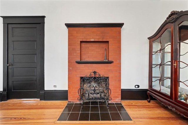 unfurnished living room featuring wood-type flooring and a fireplace