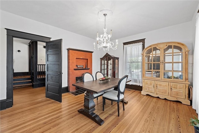 dining room with a notable chandelier and light hardwood / wood-style floors