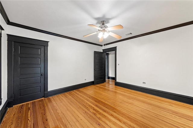 empty room with hardwood / wood-style floors, ceiling fan, and crown molding