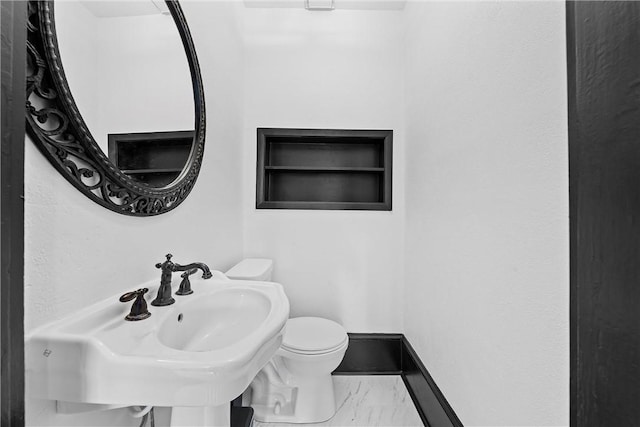 bathroom featuring toilet and sink