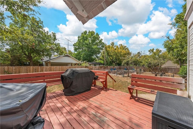 wooden terrace featuring a grill