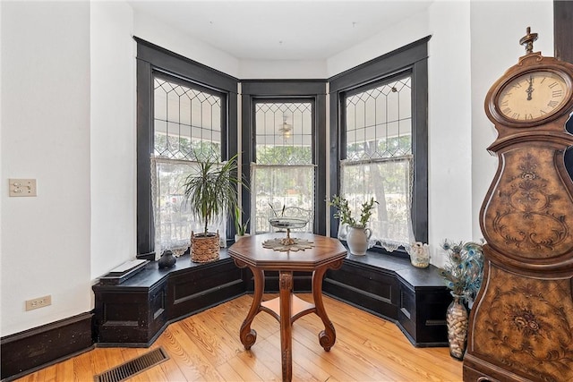 sitting room with plenty of natural light and wood-type flooring