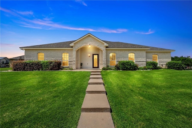 ranch-style house featuring a yard