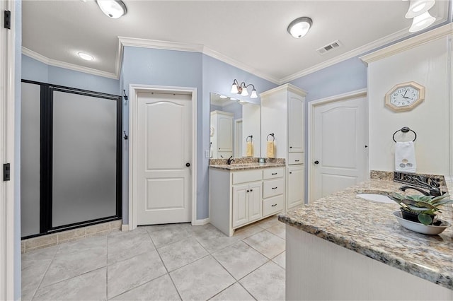 bathroom with tile patterned floors, vanity, a shower with shower door, and ornamental molding