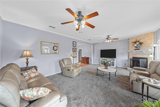 carpeted living room featuring crown molding, a large fireplace, and ceiling fan