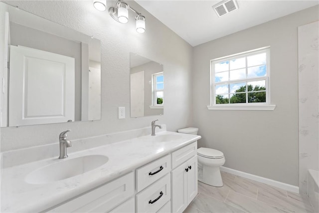 bathroom featuring vanity and toilet