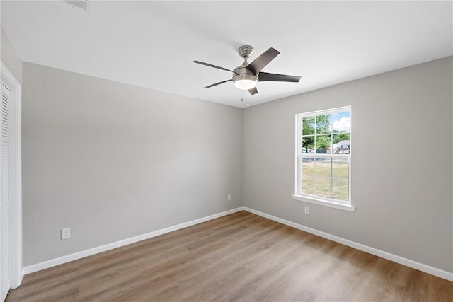 empty room featuring ceiling fan and light wood-type flooring