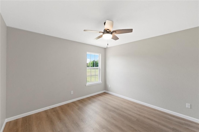 empty room featuring ceiling fan and hardwood / wood-style flooring