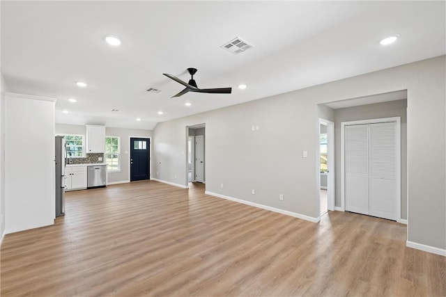 unfurnished living room featuring light hardwood / wood-style floors and ceiling fan