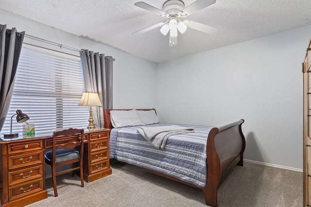 carpeted bedroom with ceiling fan and a textured ceiling