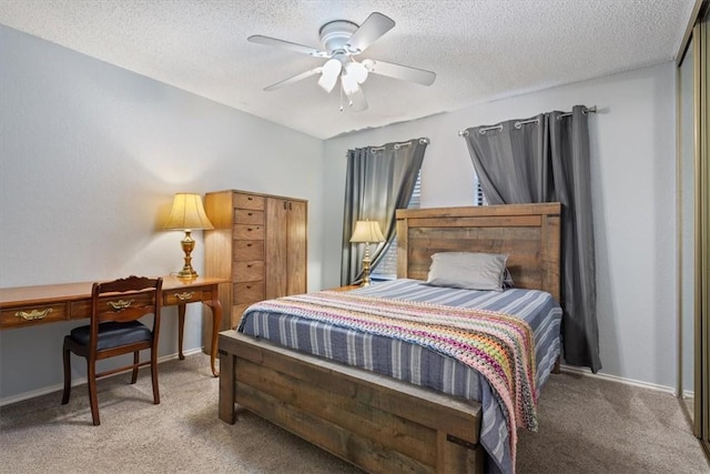 bedroom featuring carpet flooring, ceiling fan, and a textured ceiling