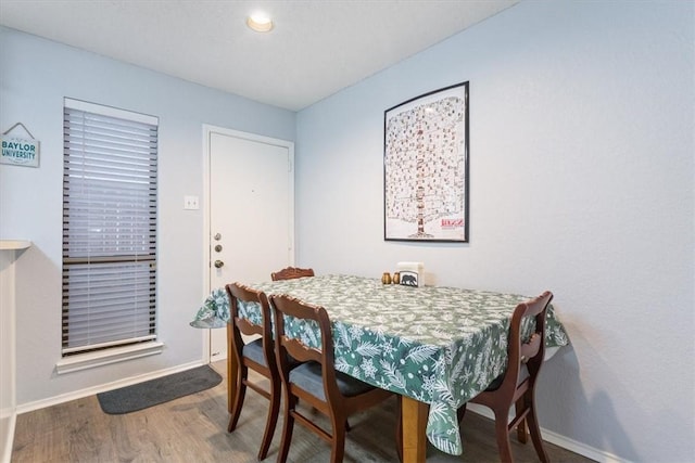 dining space with wood-type flooring