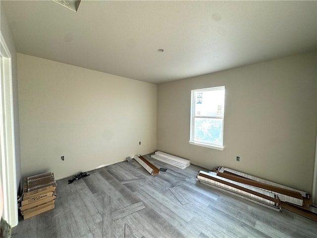 empty room with hardwood / wood-style flooring