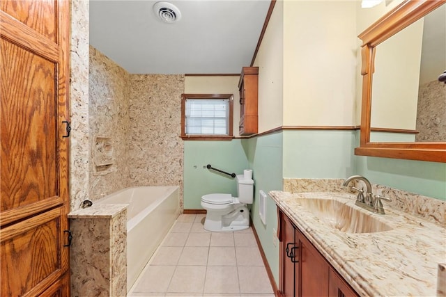 bathroom with toilet, vanity, tile patterned floors, and a bathtub