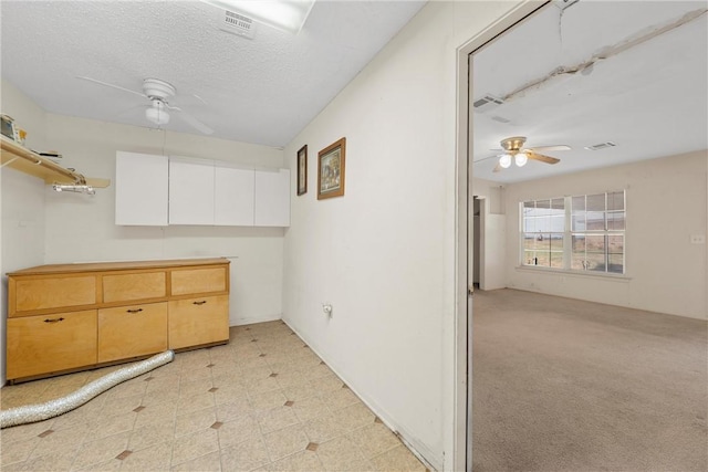 interior space featuring a textured ceiling and ceiling fan