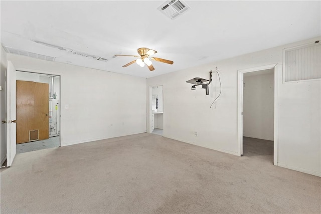 empty room featuring ceiling fan and light carpet