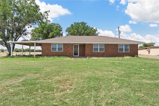 ranch-style house featuring a front lawn and a carport