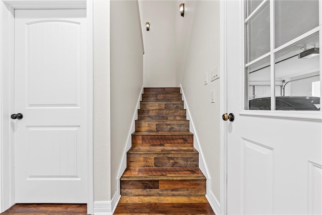 staircase featuring baseboards