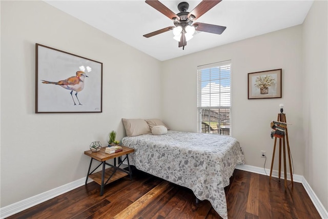 bedroom with ceiling fan, baseboards, and wood finished floors