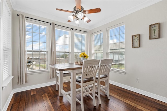 dining area with dark wood-style floors, crown molding, and baseboards