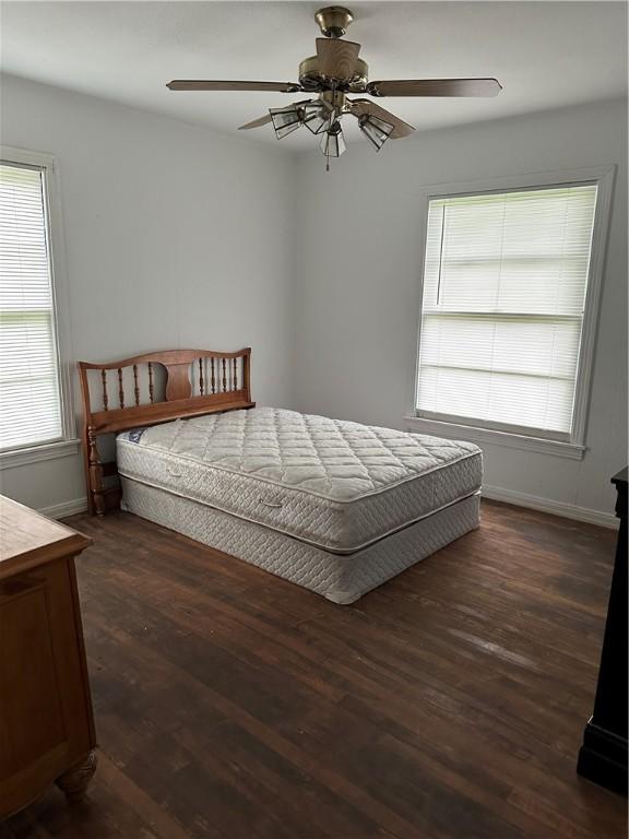 bedroom with ceiling fan and dark wood-type flooring