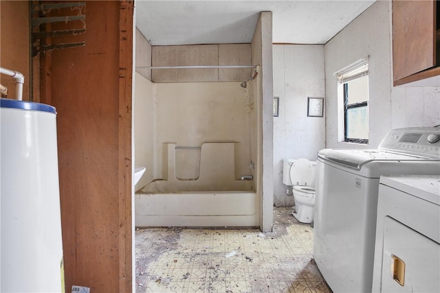 full bathroom featuring gas water heater, shower / washtub combination, vanity, washing machine and clothes dryer, and toilet