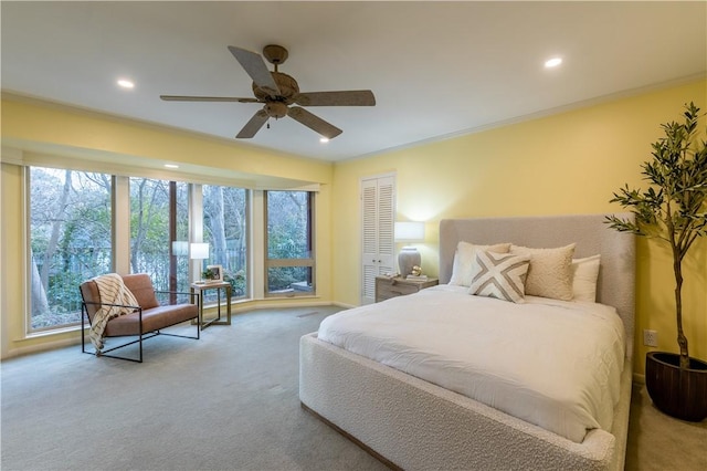 carpeted bedroom with ornamental molding and ceiling fan