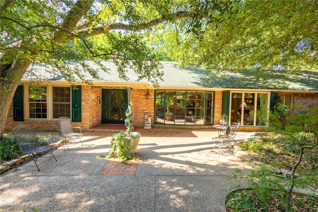 back of property with a patio