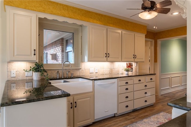 kitchen with sink, white cabinetry, crown molding, wood-type flooring, and dishwasher