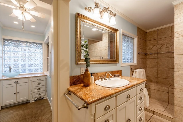 bathroom featuring ornamental molding, plenty of natural light, vanity, and ceiling fan